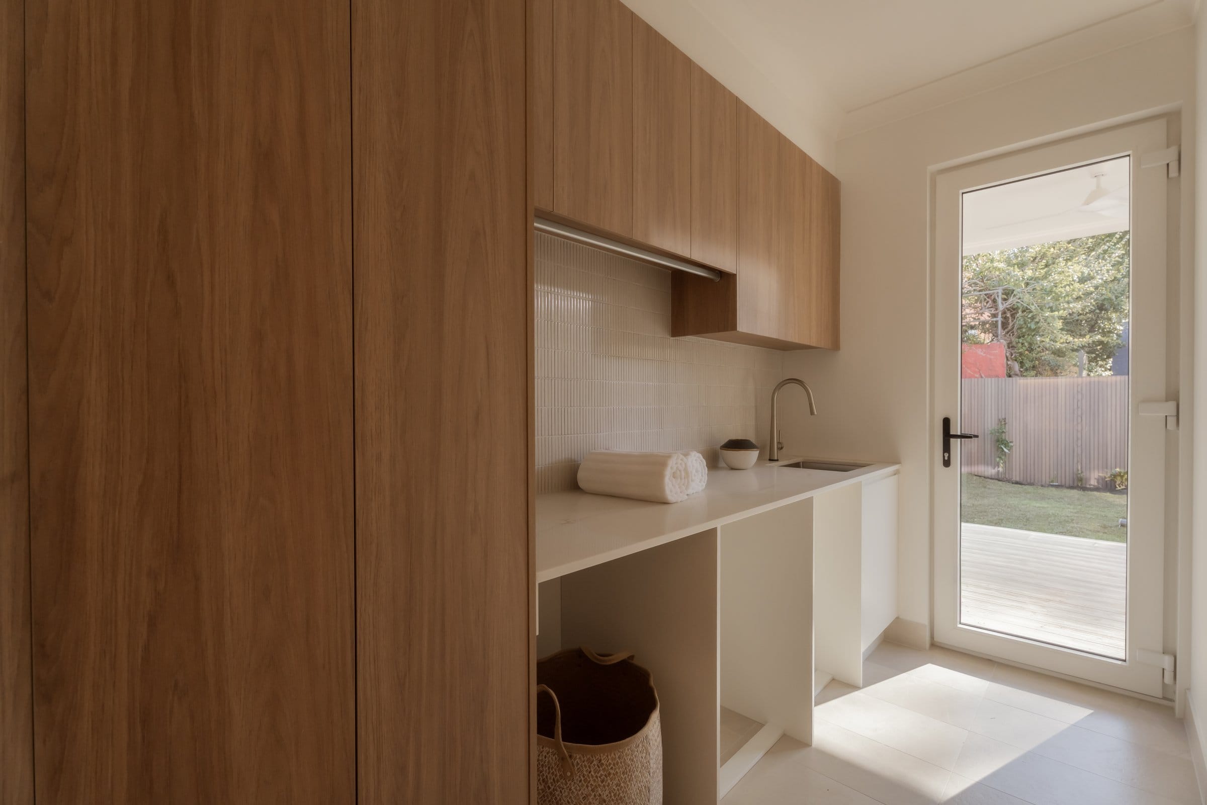 Laundry with full-height oak joinery and garden access