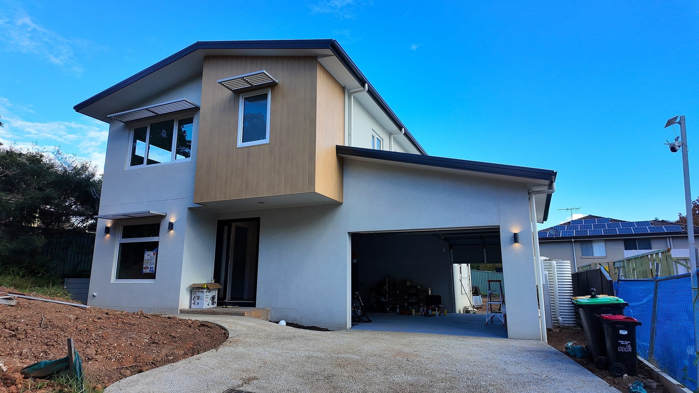 Dundas home facade, a two-storey infill home with a rendered base, timber-look clad upper level and integrated garage