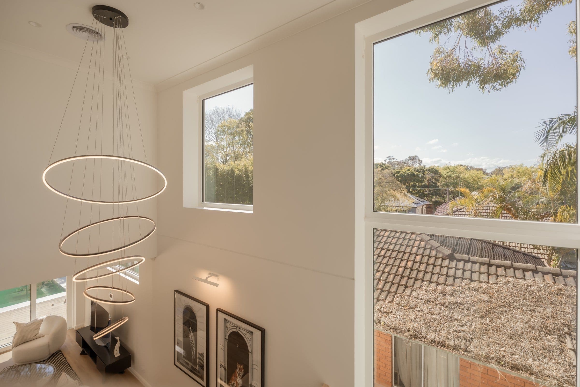 Double-height living room at the Lilyfield passive house, looking out over Inner West rooftops