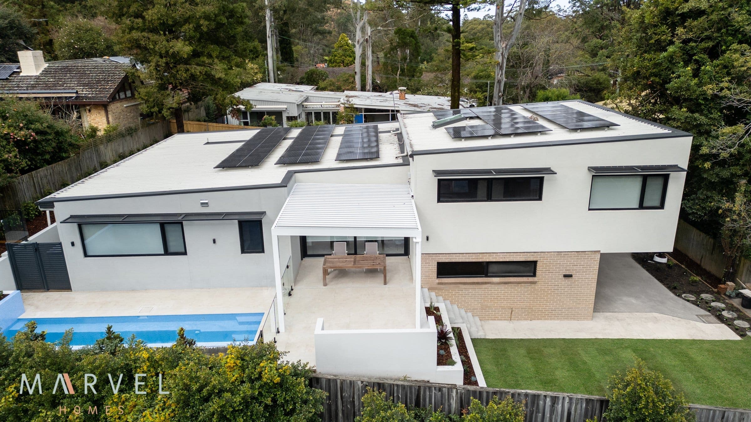 Completed Marvel Homes knock-down rebuild in Warrawee, Upper North Shore Sydney, showing rooftop solar, pool and a new passive house on a sloping block