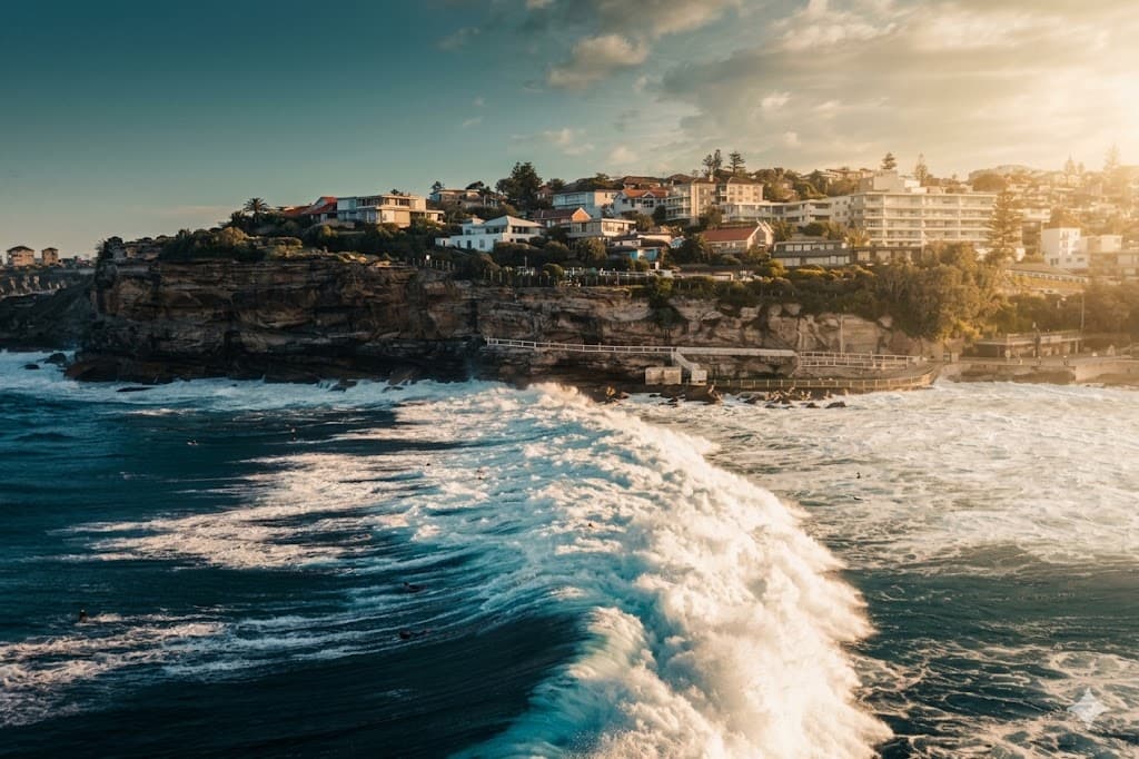 A wave breaking beneath the cliffs at Bondi, Sydney